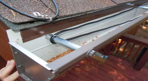 What are the benefits and drawbacks of using heat tape on gutters?
